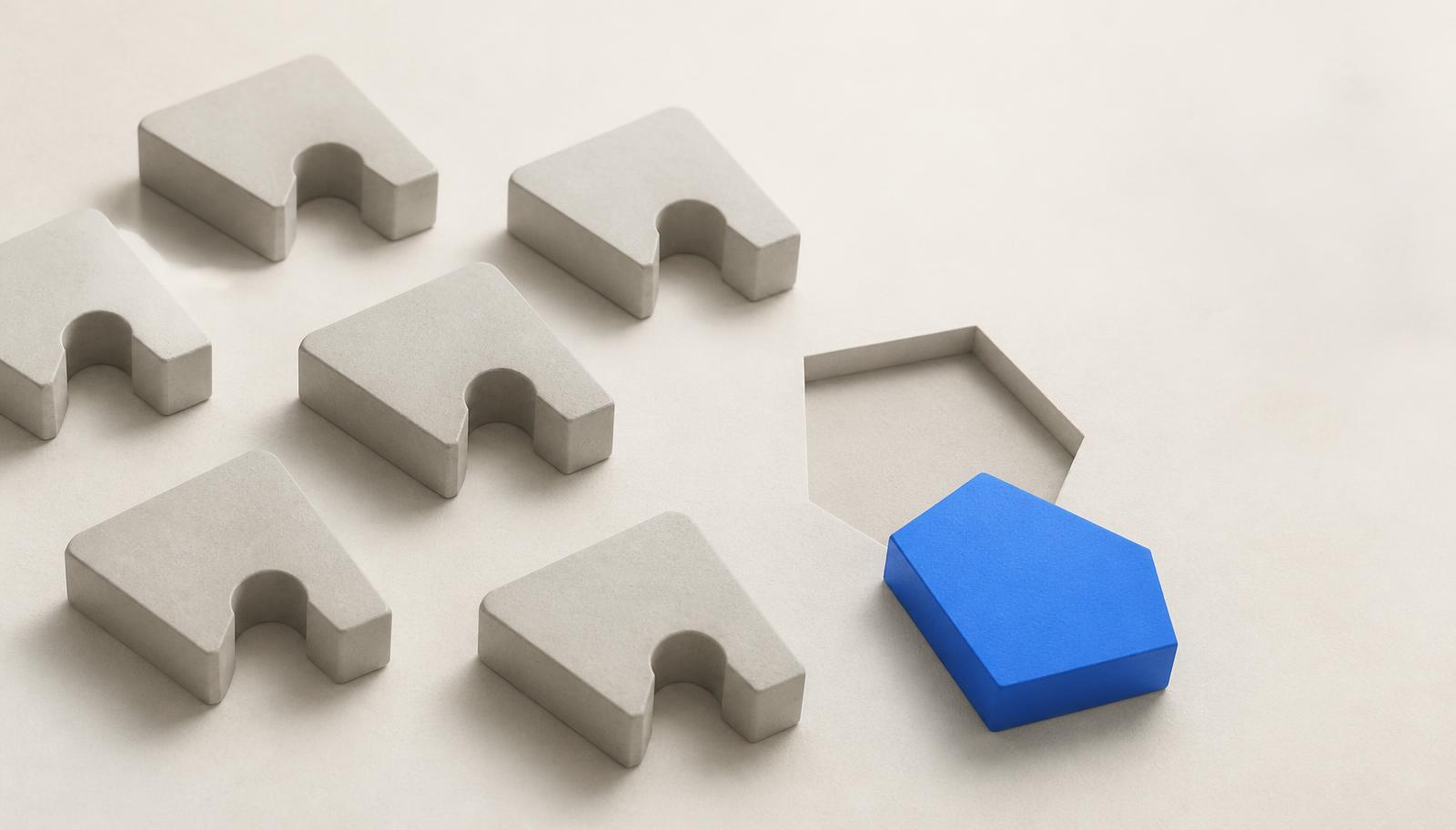 Identical gray shapes beside a single blue shape that fits a differently shaped opening